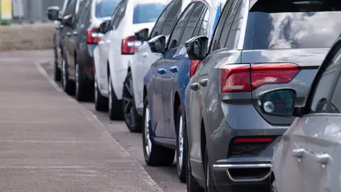 Long row of cars parked along the road
